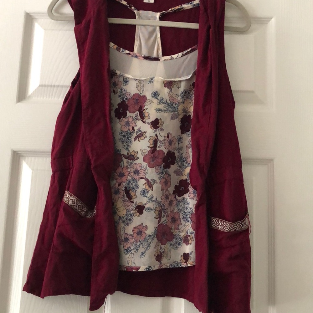 A floral tank top and a sleeveless hooded jacket.